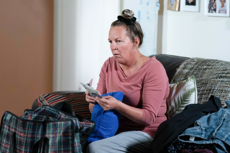 Karen Taylor counting money on a sofa.