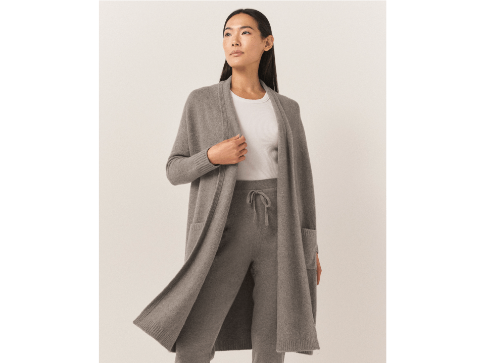Woman wearing a gray cardigan and matching sweatpants.