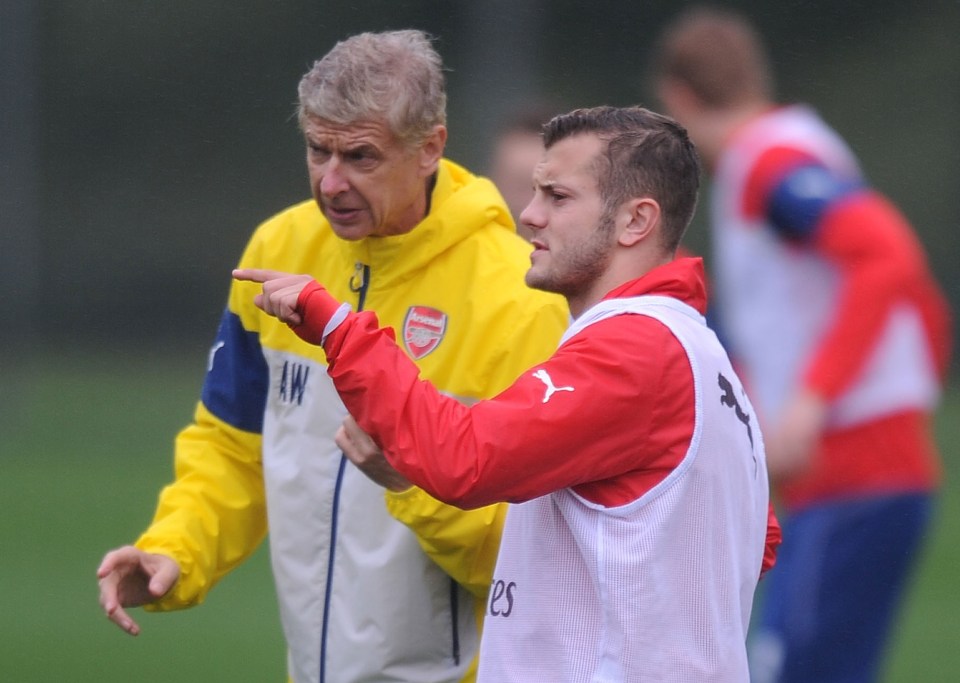 Arsene Wenger coaching Jack Wilshere at an Arsenal training session.