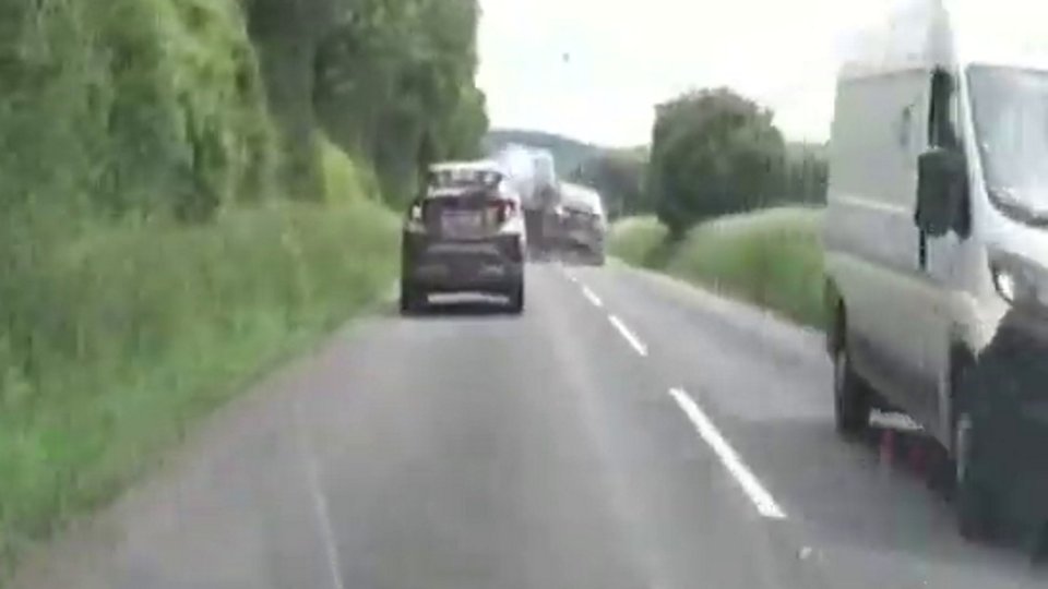 A car speeding down a country road during a police chase.