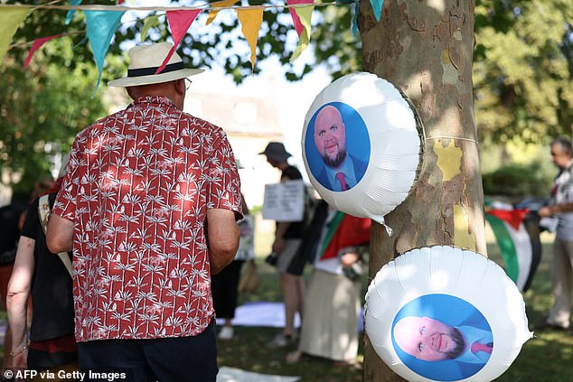 Protestors draped balloons with the JD Vance mem on them around trees and held aloft Palestinian flags in the village where the vice president is holidaying