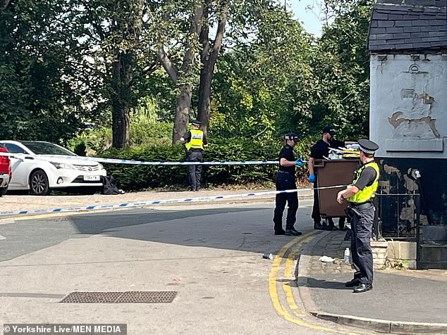 Any motorists who were in the Doncaster Road area, described as 'busy on most evenings', between 9.30pm and 9.45pm on August 3 have been urged to check their dashcam footage. Pictured: police seen investigating in a bush and nearby bin following the shooting on August 12