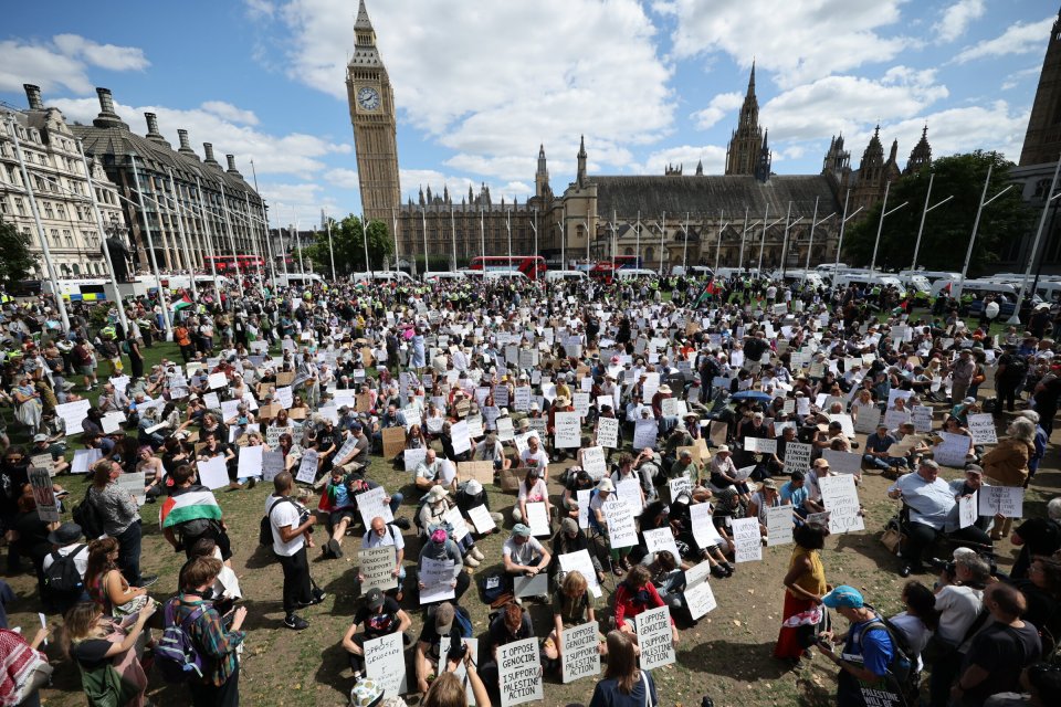 Protesters in Parliament Square holding signs that say "I oppose genocide. I support Palestine action."