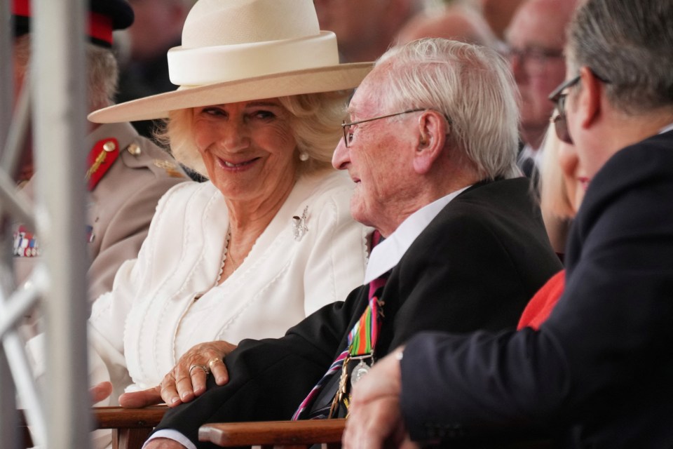 Queen Camilla speaking with a guest at a VJ Day memorial service.