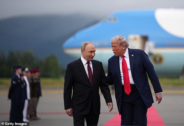 Trump guides Putin with a hand on his back towards a photo-op in front of Air Force One