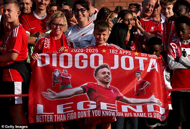 Fans held up flags at Anfield as they paid their respects to a popular figure around the club
