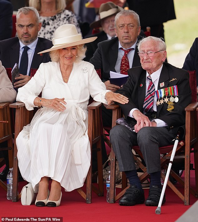 Queen Camilla spent the service sitting next to former Royal Navy submarine telegraphist, John Harlow, 100 (right)