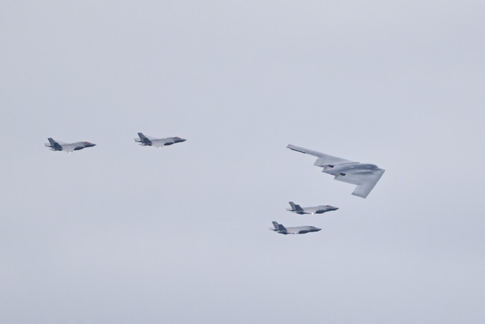 F-35 jets and a B-2 bomber in flight.