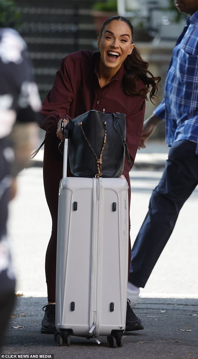 An ecstatic Vicky Pattison was seen dragging along her suitcase as she headed inside