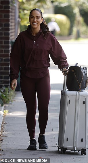 The star was appropriately dressed in a sporty burgundy co-ord and trainers
