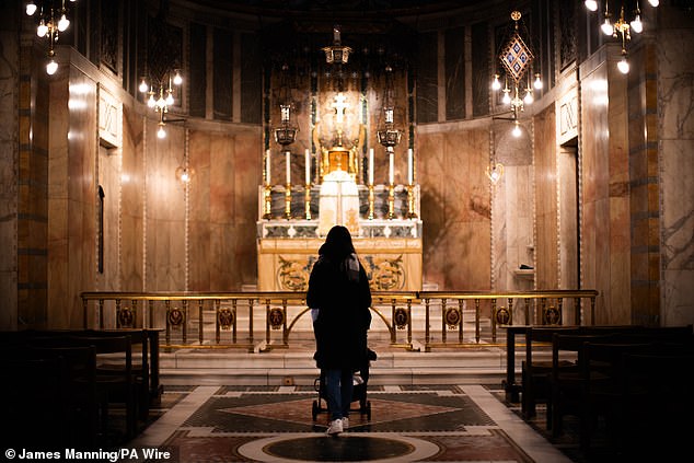 Pictured: A lady mourns at Westminster Cathedral in central London, following the death of Pope Francis