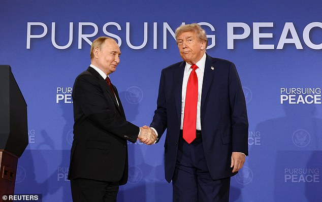 Trump and Putin shake hands during a press conference following their meeting in Alaska on Friday