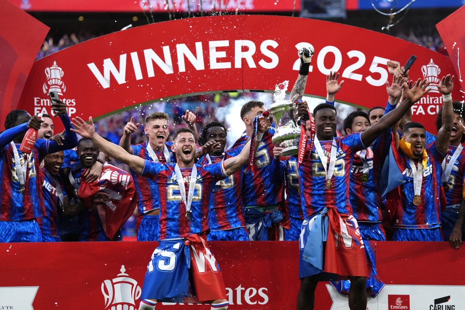 Crystal Palace players celebrating with the Emirates FA Cup trophy.