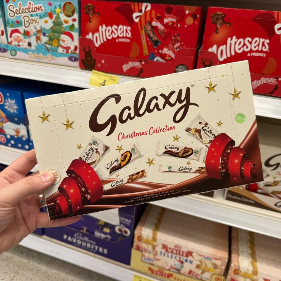 Hand holding a box of Galaxy Christmas Collection chocolates.