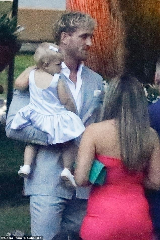 Logan wore a pale grey pinstriped suit with a white handkerchief in his pocket
