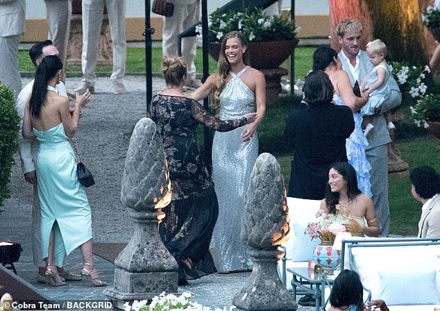 She greeted guests as her better half held on to their daughter, right