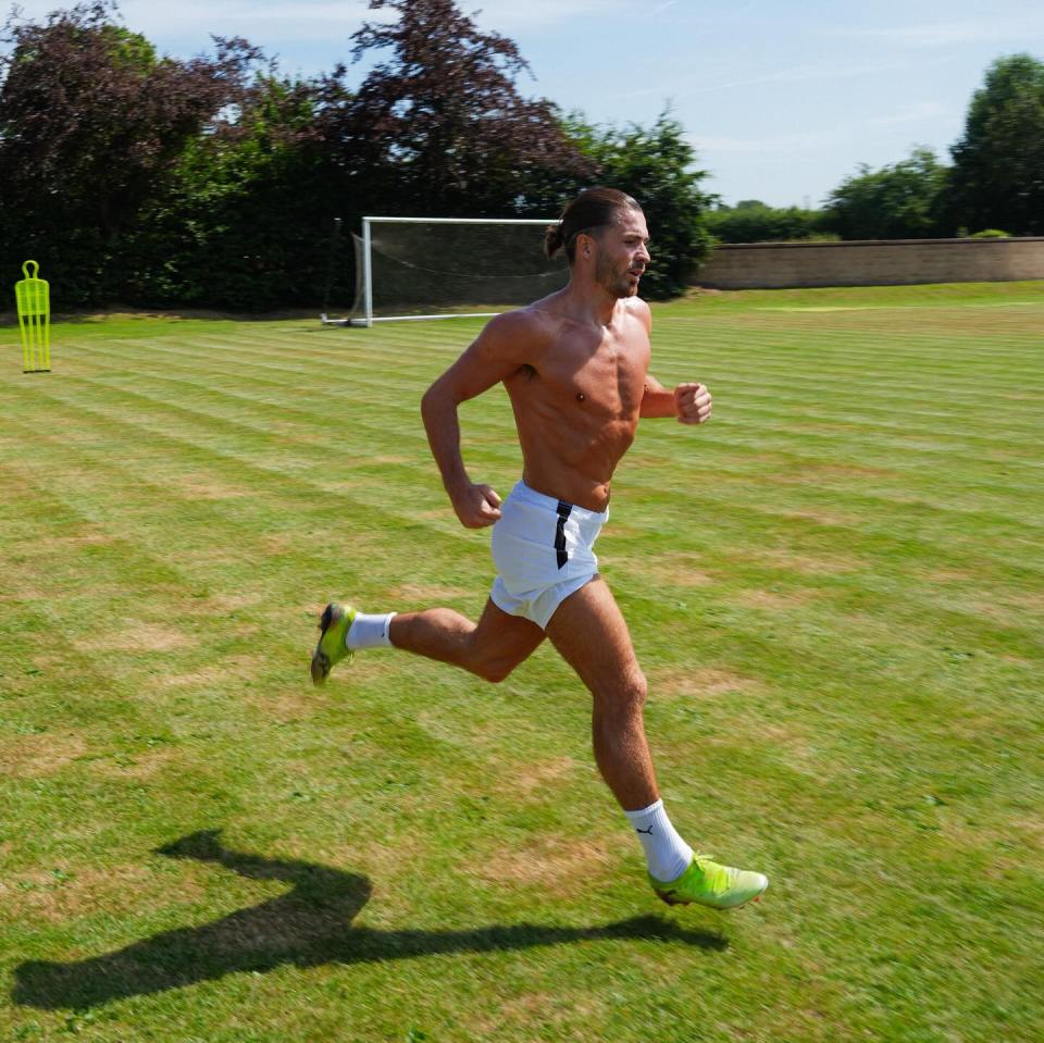 Jack Grealish running on a soccer field.