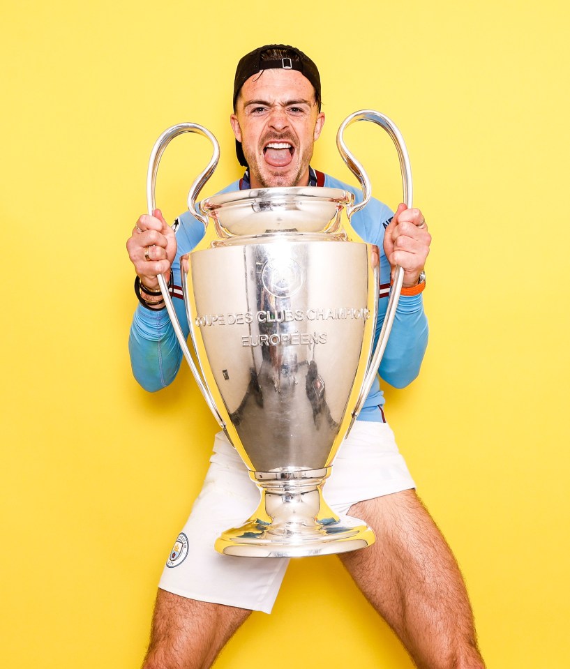 Jack Grealish holding the UEFA Champions League trophy.
