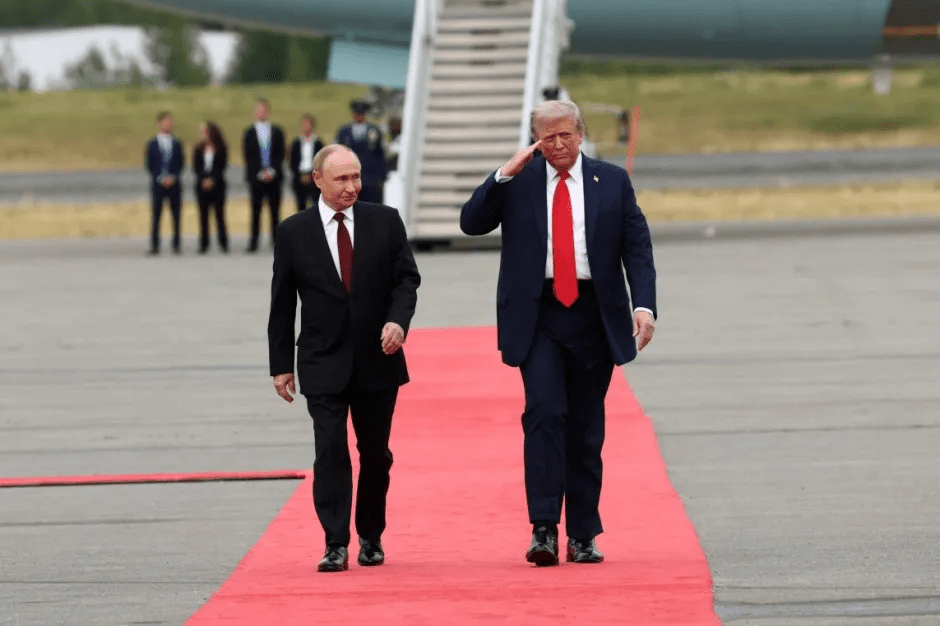 Putin and Trump walking on a red carpet.