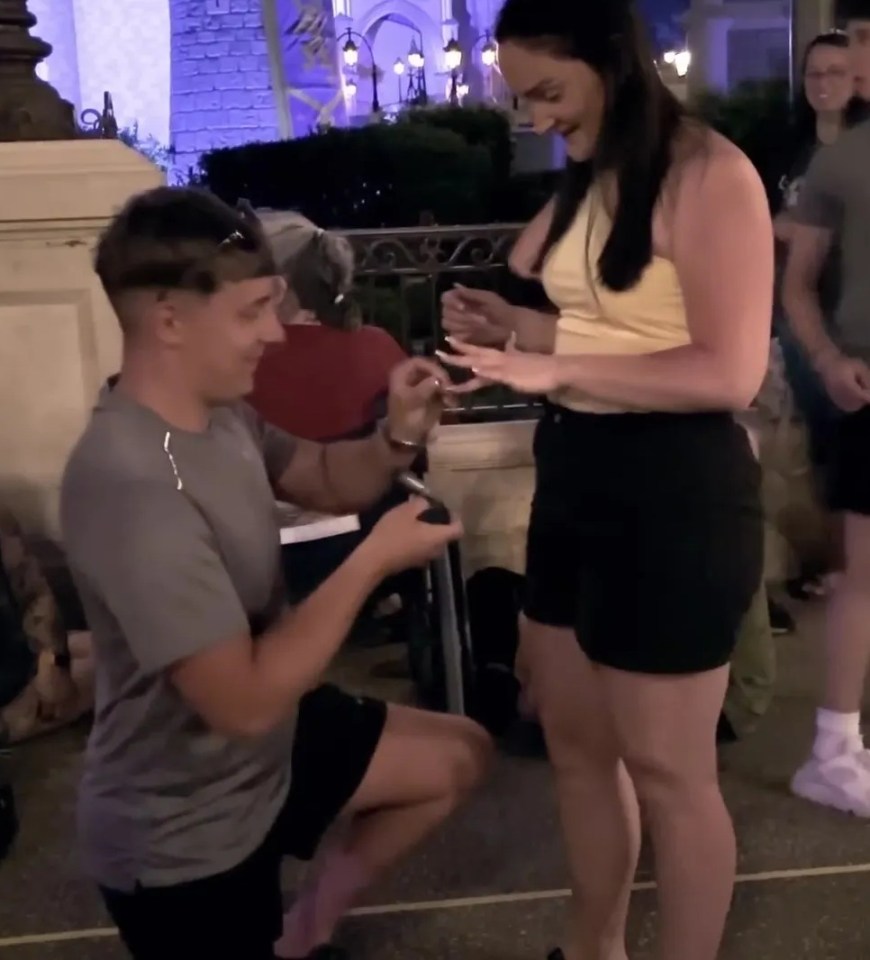 A man proposing to a woman at Disney.