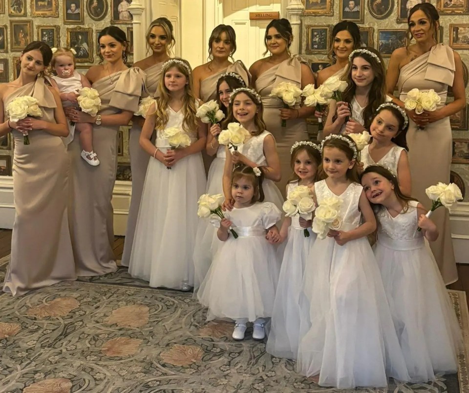 Bridesmaids and flower girls in a wedding photo.