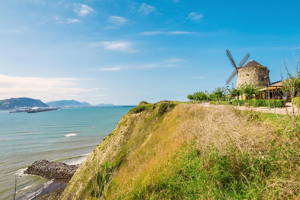 Old windmill on a cliff overlooking the ocean in Getxo, Spain.