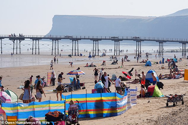 It comes as the UK has been experiencing hotter summers than ever, with Brits battling temperatures as high as 35C and warnings it could last longer (Pictured: families at Saltburn-by-the-Sea in North Yorkshire)