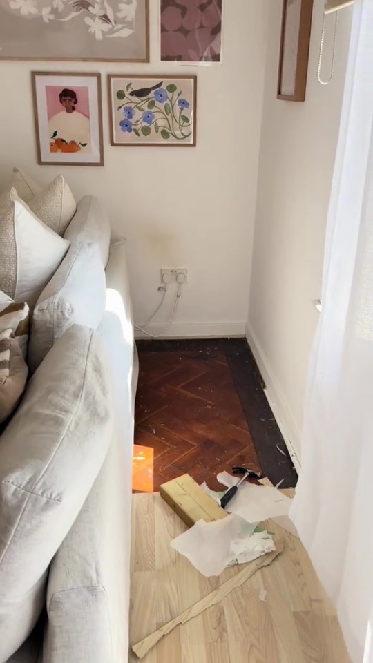 Woman removing floorboards in her apartment.