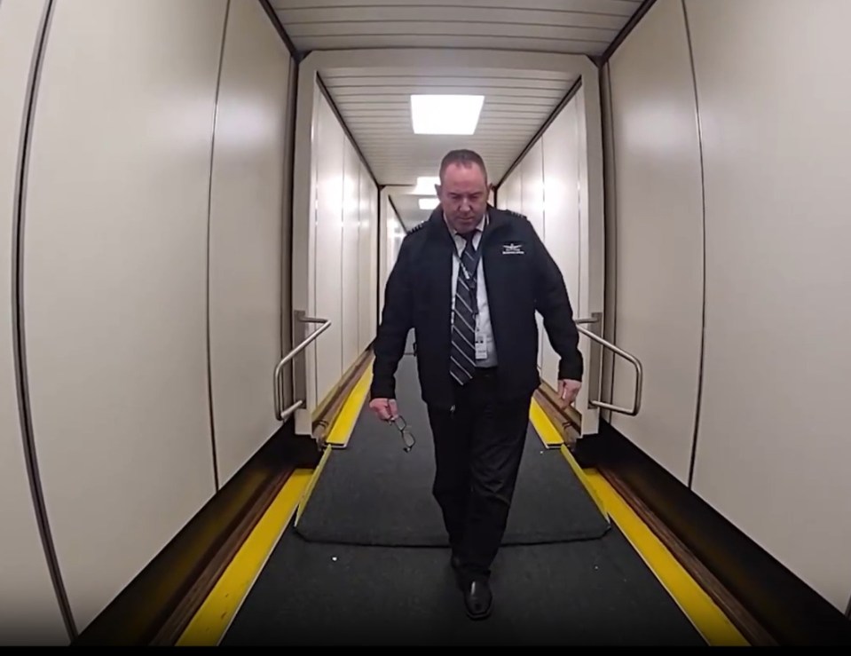 Pilot escorted from plane.