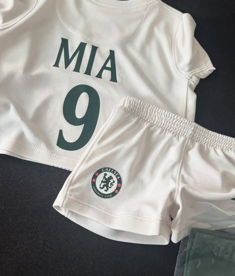 Chelsea soccer jersey and shorts with "Mia 9" on the back.