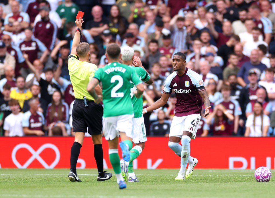 Referee showing Ezri Konsa a red card during a soccer match.