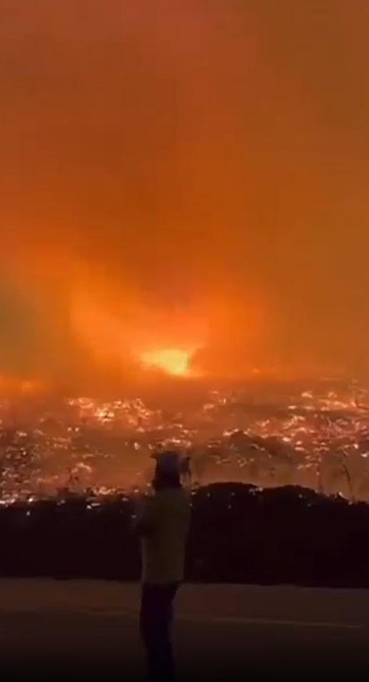 Person watching large wildfire.