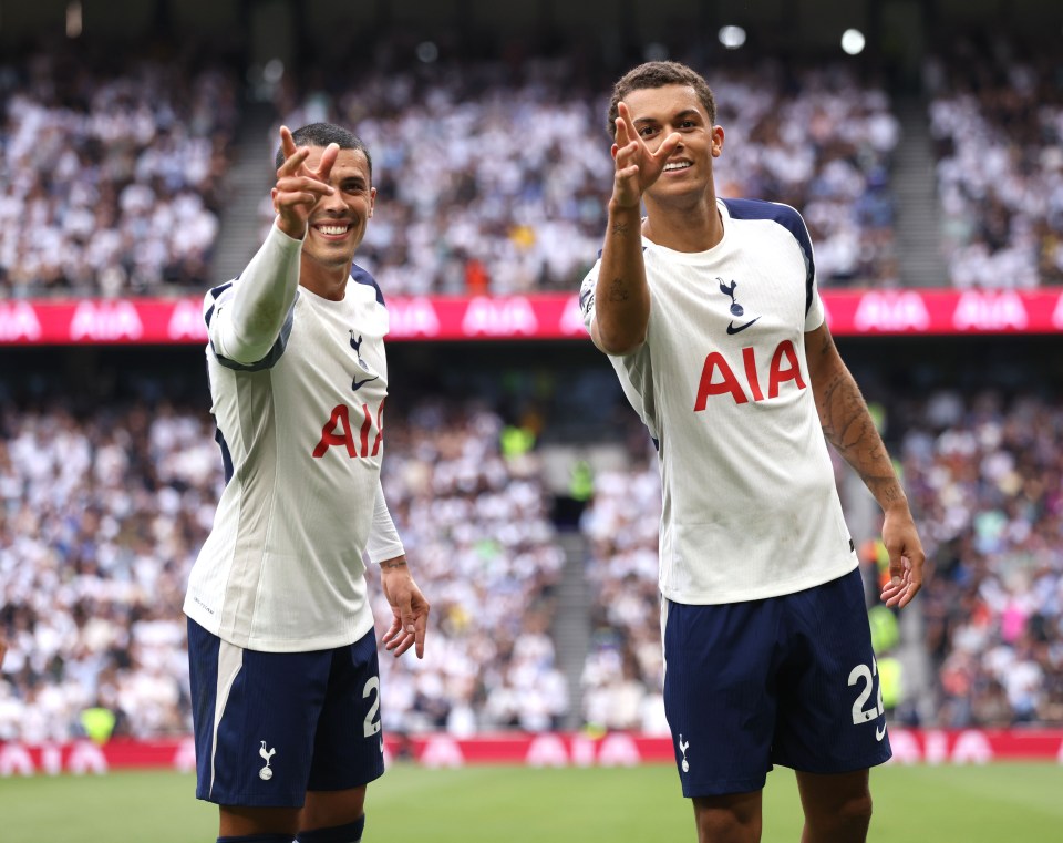 Two Tottenham Hotspur players celebrating a goal.