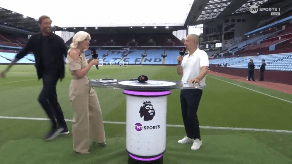 Three sportscasters at a soccer stadium.