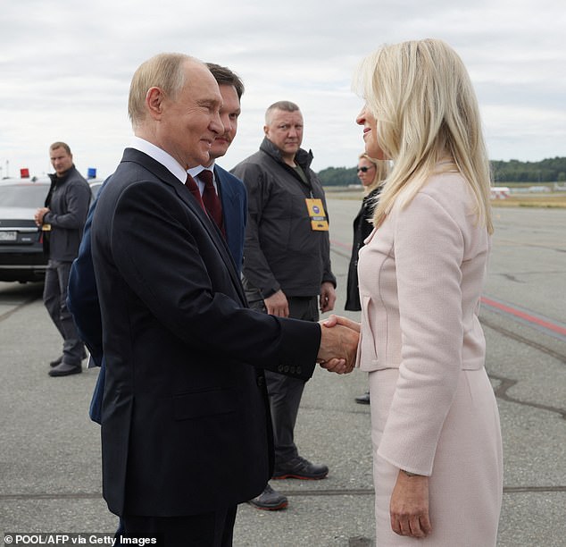 Monica Crowley looked pretty in pink as she shook hands with Putin as he took off from Elmendorf Air Force Base in Anchorage, Alaska, on Friday