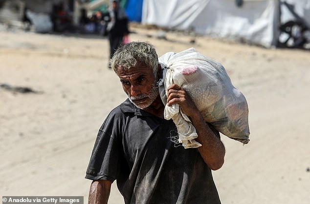 The UN human rights today warned that at least 1,760 Palestinians had been killed while seeking aid in Gaza since late May. Pictured: Palestinians displaced by Israeli attacks flock to a US aid distribution center to receive food assistance in Rafah, Gaza, on August 14