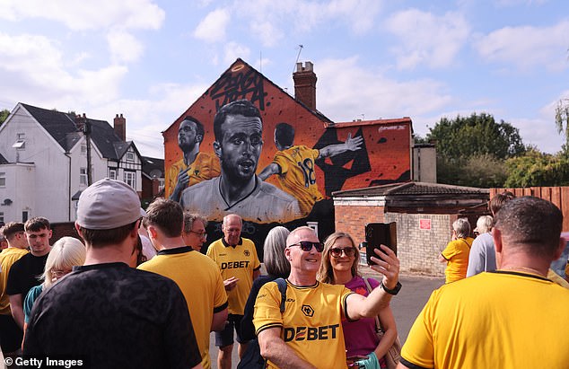 Fans visit a mural devoted to Jota on a road near Molineux ahead of their clash with Man City