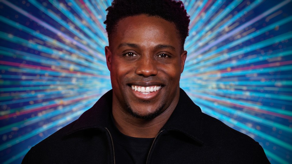 Portrait of a smiling man in a black jacket.