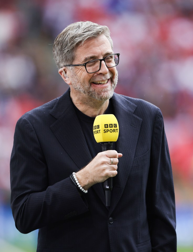 Mark Chapman holding a BBC Sport microphone.