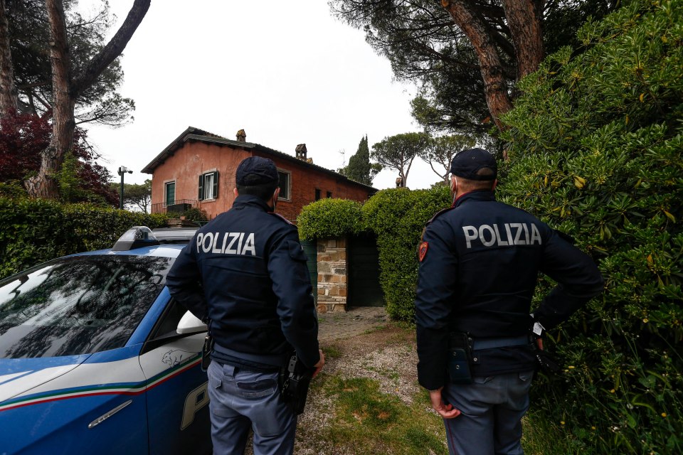 Police officers outside a home following a reported robbery.