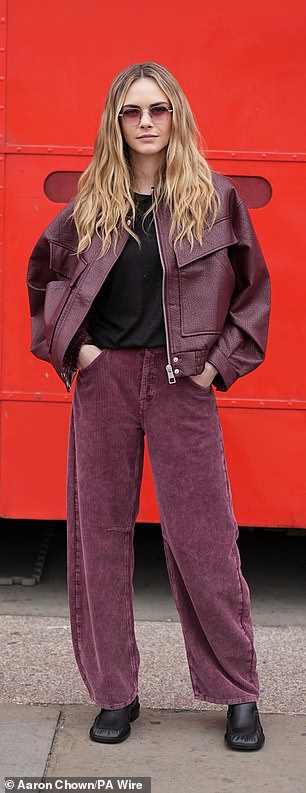 Cara turned heads as she stepped out in a maroon leather jacket which she layered over a black T-shirt