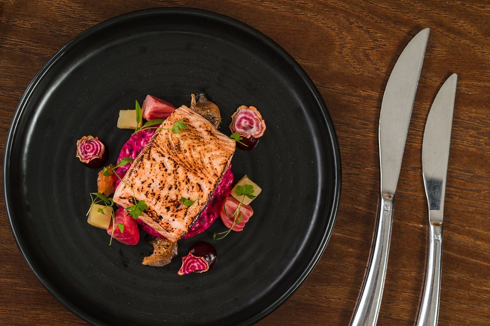 Pan-seared salmon with beetroot purée and vegetables.
