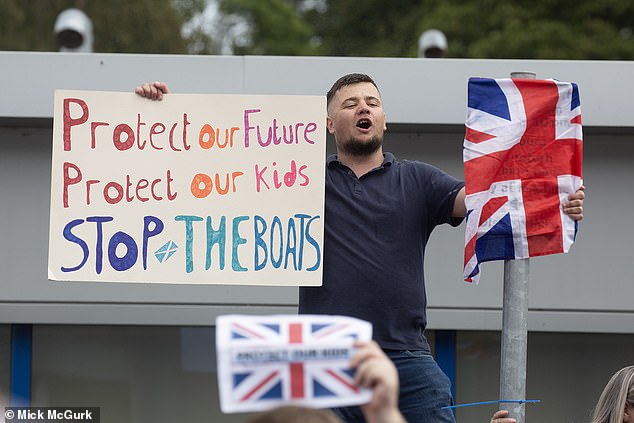 One placard read: 'Stop the boats,' in reference to illegal crossings made by asylum seekers in small boats