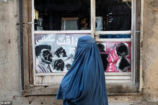 The Taliban's supreme leader has issued an order banning the construction of windows in residential buildings that overlook areas used by Afghan women. Pictured: An Afghan woman stands at a window in Kabul on January 31, 2024