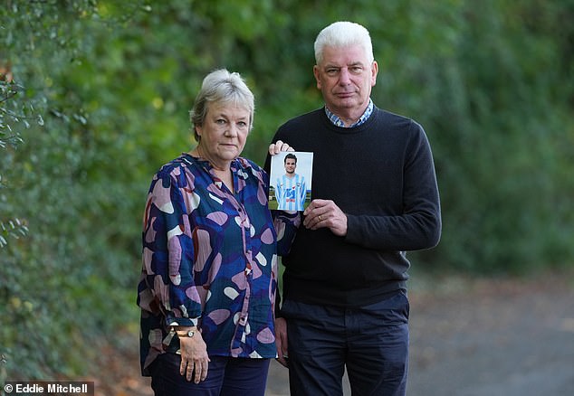 Caroline, 64, and Bob Schilt, 70, are pictured holding up a picture of their son Jacob who died in the Shoreham airshow disaster