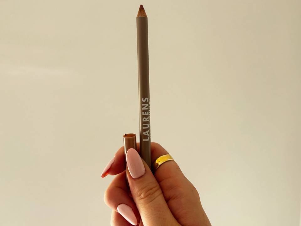 Hand holding Laurens lip liner.