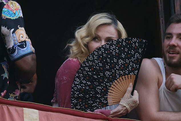 Madonna kept cool in the Italian heat with a fan