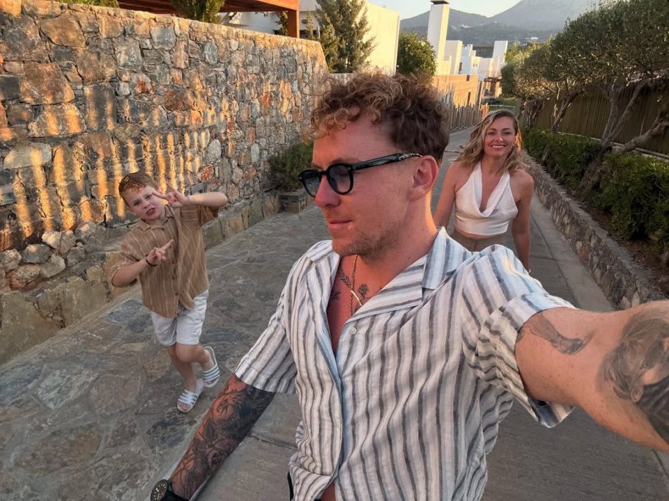 Selfie of a man, woman, and child on a family vacation.