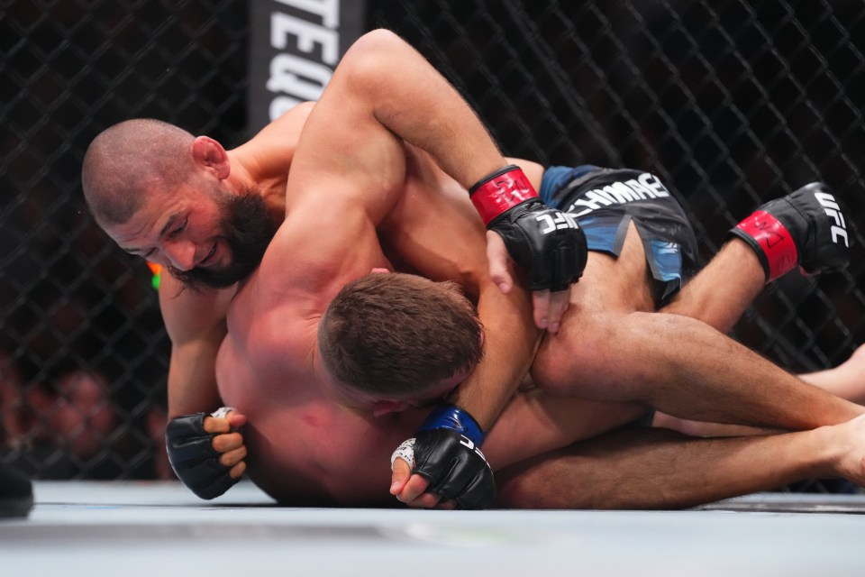 Khamzat Chimaev of Russia controlling Dricus du Plessis of South Africa during a UFC match.
