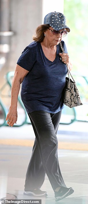 While running errands, she added touches of glamour into her look as she wore a rhinestone-covered baseball cap paired with oversize, rose-tinted sunglasses